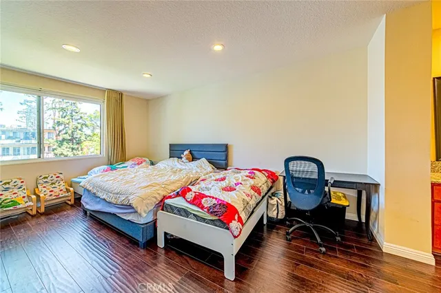 a bedroom with a bed chair and window