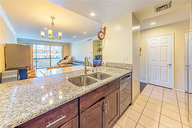 a kitchen with granite countertop a sink and a wooden floor