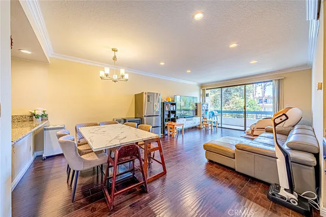 a dining room with furniture and wooden floor