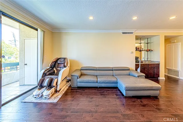 a bedroom with furniture and wooden floor