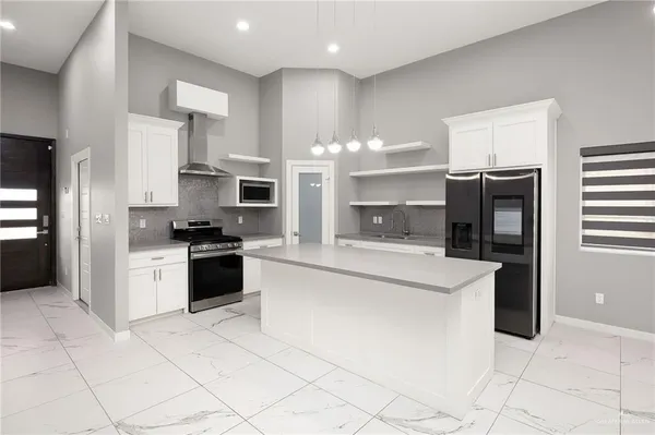 a large kitchen with cabinets and stainless steel appliances