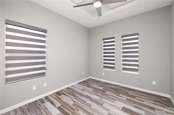 a view of a room with a window and a ceiling fan