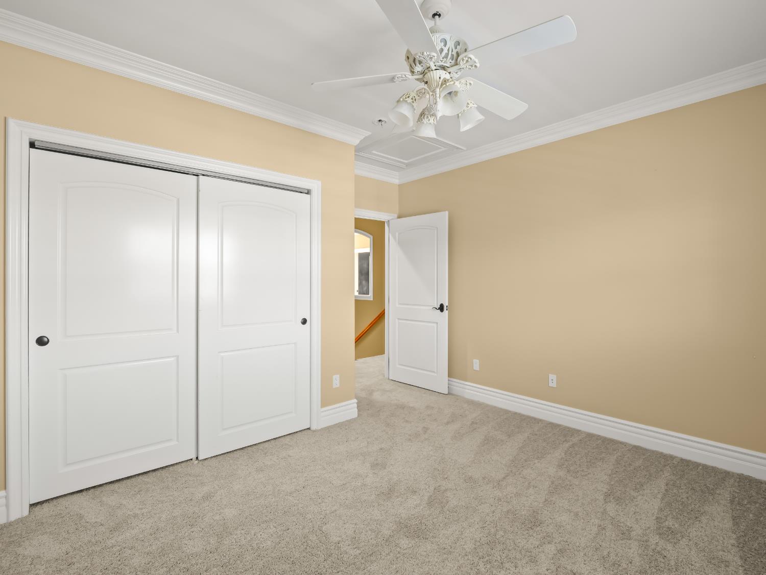 17113 Mark Road Madera, CA 93636 - Photo 38 of 99 an empty room with a chandelier fan and closet