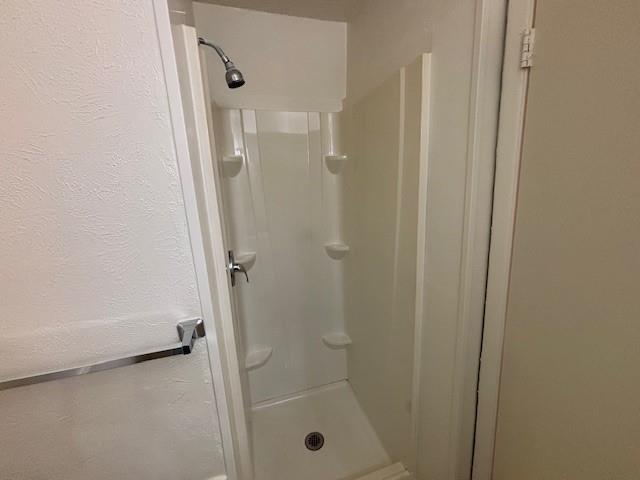 760 East Pecan Street Hurst, TX 76053 - Photo 12 of 16 a bathroom with a glass shower door