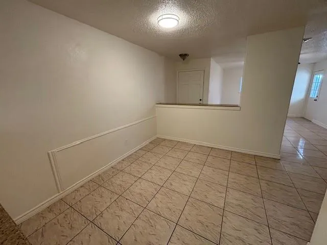 a view of an empty room with a fan