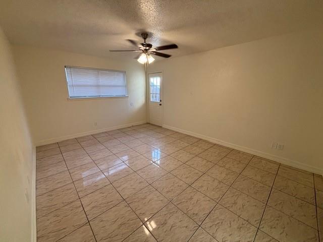 760 East Pecan Street Hurst, TX 76053 - Photo 4 of 16 a view of an empty room with a fan
