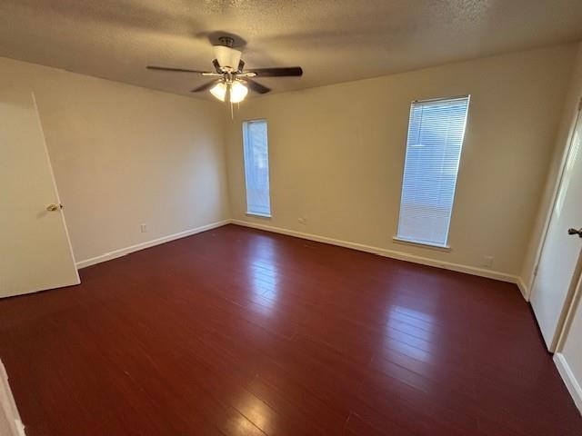 760 East Pecan Street Hurst, TX 76053 - Photo 9 of 16 a view of an empty room with wooden floor and a ceiling fan