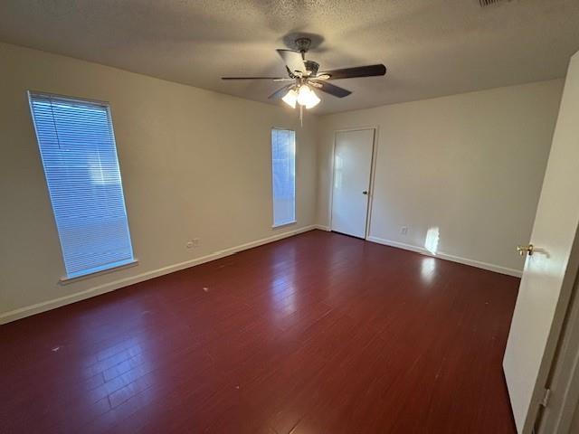 760 East Pecan Street Hurst, TX 76053 - Photo 10 of 16 a view of an empty room with wooden floor and a ceiling fan