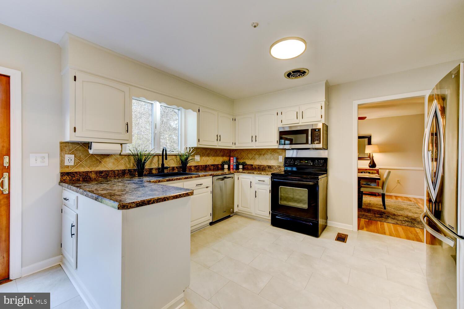 6 Coventry Circle Princeton Junction, NJ 08550 - Photo 16 of 70 a kitchen with stainless steel appliances granite countertop a stove sink and cabinets