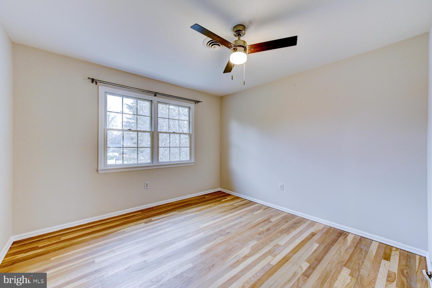 6 Coventry Circle Princeton Junction, NJ 08550 - Photo 39 of 70 an empty room with wooden floor fan and windows