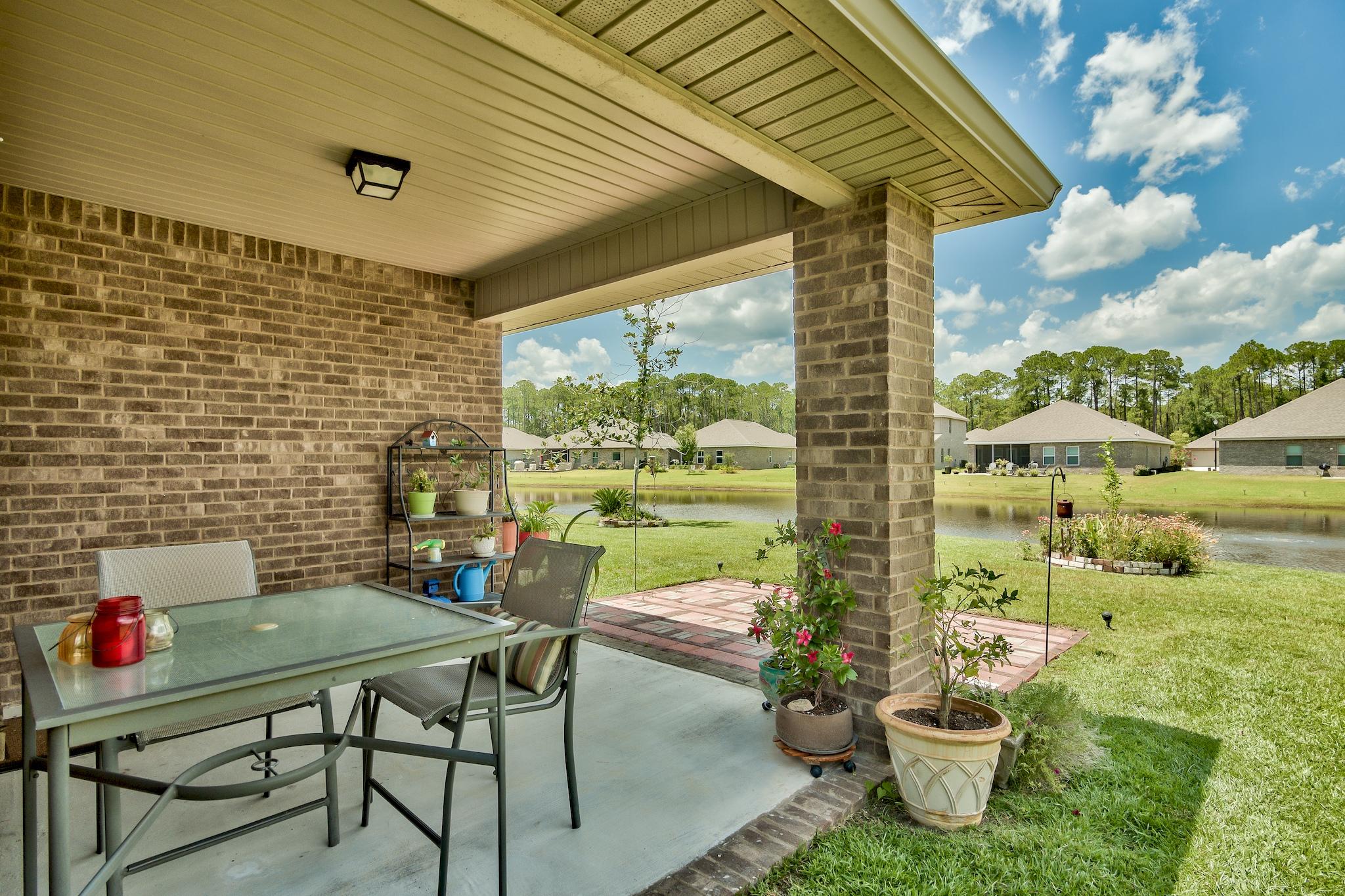 134 Pin Oak Loop Santa Rosa Beach, FL 32459 - Photo 28 of 51 a backyard of a house with outdoor seating
