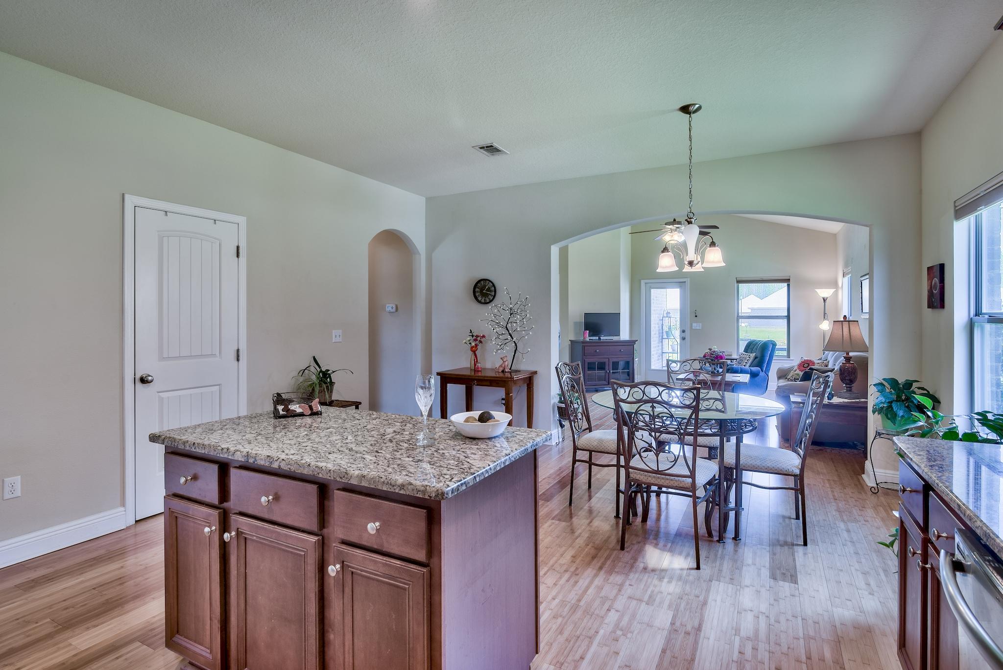 134 Pin Oak Loop Santa Rosa Beach, FL 32459 - Photo 10 of 51 a view of a dining room and livingroom with furniture wooden floor a chandelier