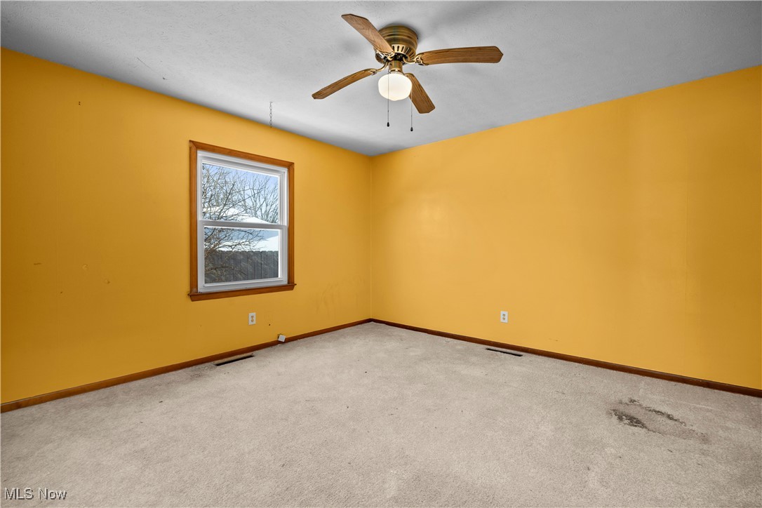 14015 West Lake Road Vermilion, OH 44089 - Photo 36 of 50 Empty room featuring carpet and ceiling fan