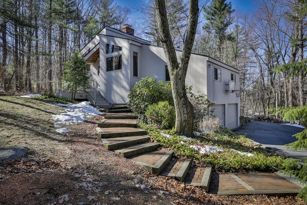 a front view of house with yard and green space