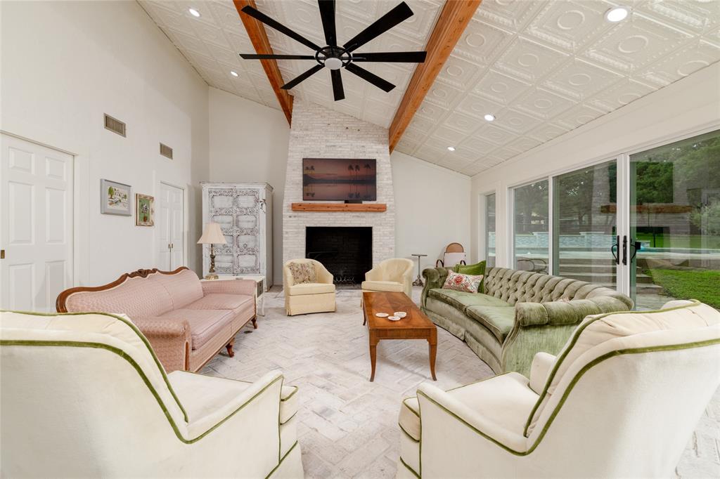 8948 David Fort Road Argyle, TX 76226 - Photo 17 of 39 Spacious living area featuring a vaulted ceiling with decorative ceiling tiles, exposed wood beams, and recessed lighting