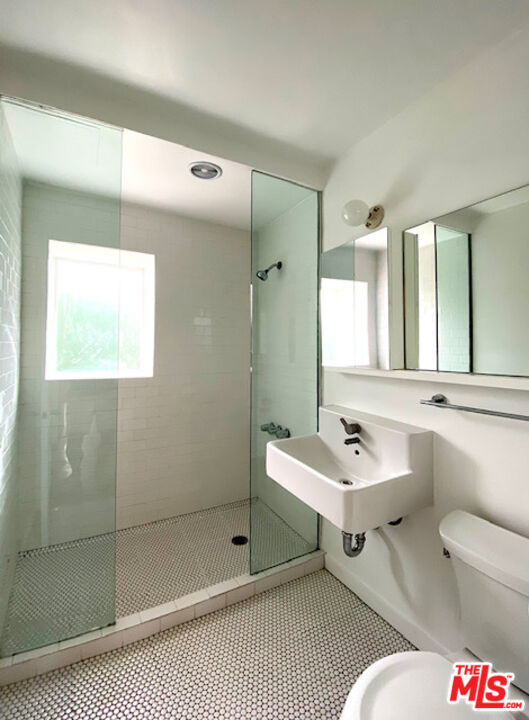 1819 Euclid Street Santa Monica, CA 90404 - Photo 11 of 55 a en suite bathroom with a sink mirror and shower