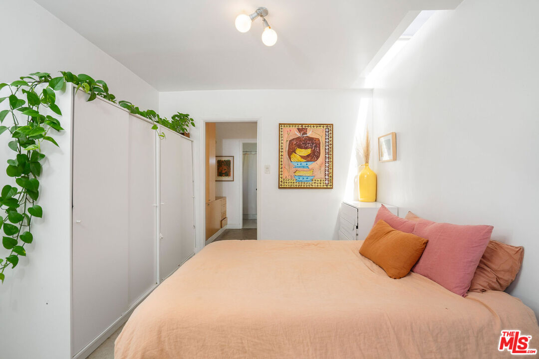1819 Euclid Street Santa Monica, CA 90404 - Photo 23 of 55 a bedroom with a bed and a potted plant