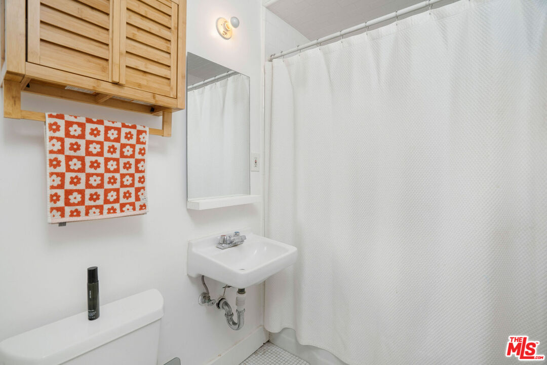 1819 Euclid Street Santa Monica, CA 90404 - Photo 25 of 55 a bathroom with a sink and a mirror