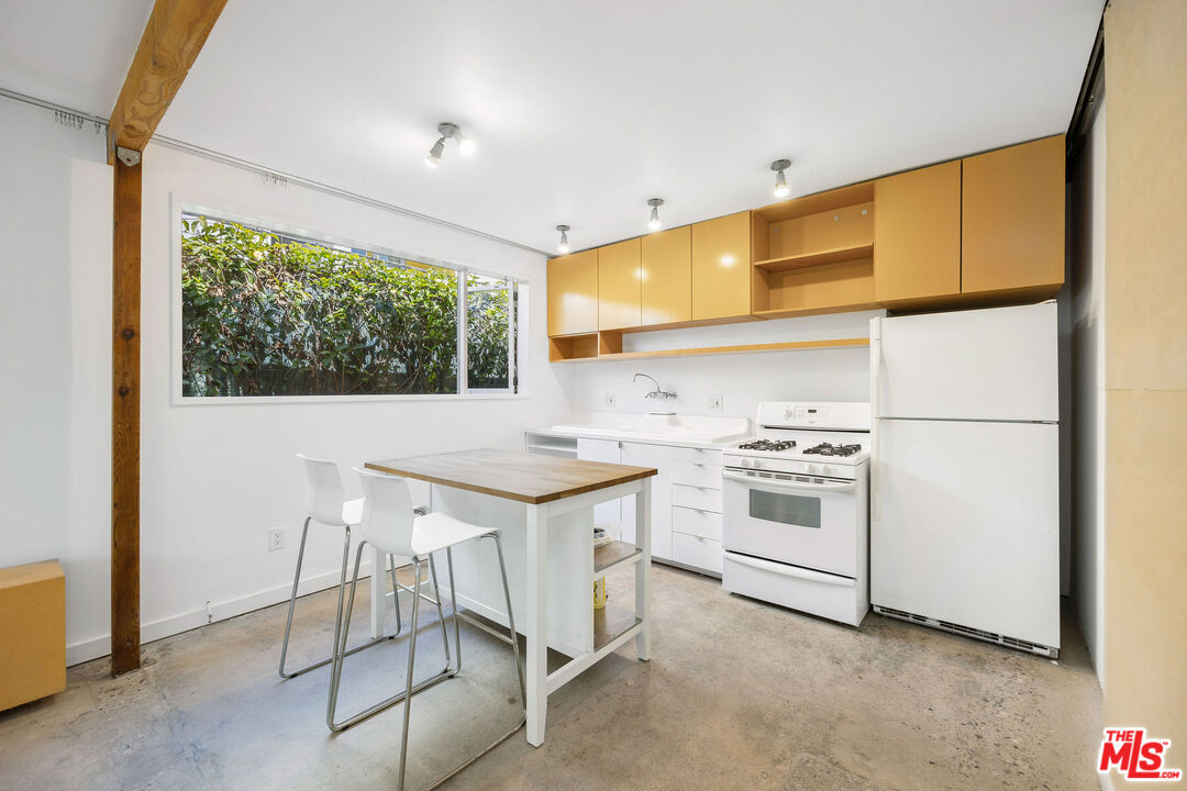 1819 Euclid Street Santa Monica, CA 90404 - Photo 41 of 55 a kitchen with white cabinets and white appliances