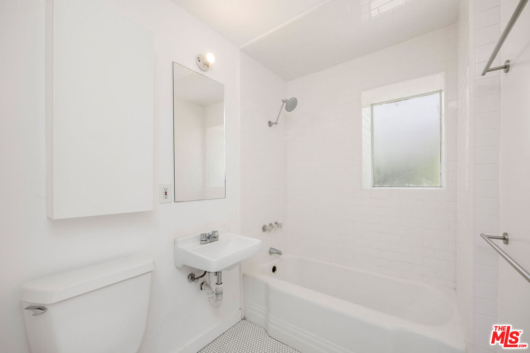 1819 Euclid Street Santa Monica, CA 90404 - Photo 43 of 55 a bathroom with a sink a toilet and shower