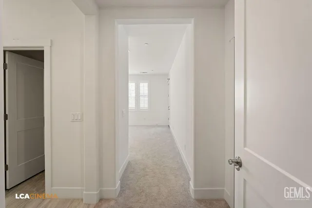 a view of a hallway with wooden floor and closet