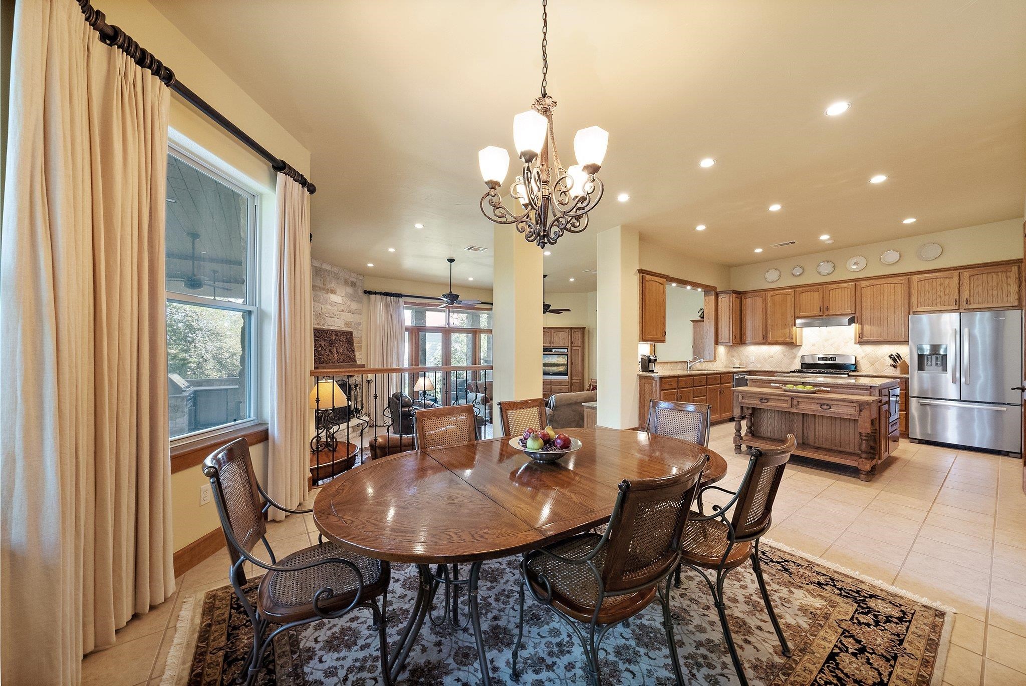 304 Hi Ridge Road Horseshoe Bay, TX 78657 - Photo 18 of 30 a view of a dining room with furniture and a chandelier