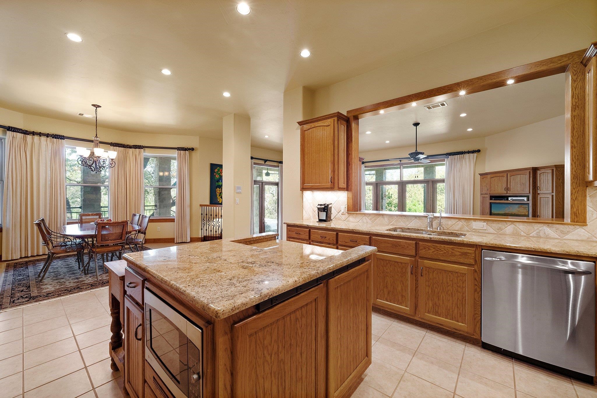 304 Hi Ridge Road Horseshoe Bay, TX 78657 - Photo 21 of 30 a kitchen with granite countertop sink stove and cabinets