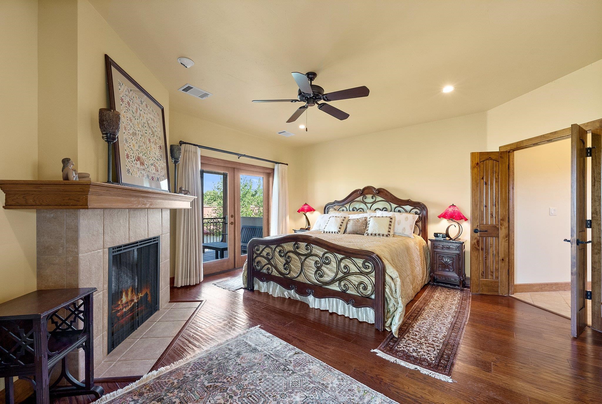 304 Hi Ridge Road Horseshoe Bay, TX 78657 - Photo 27 of 30 a bedroom with a bed and a fireplace