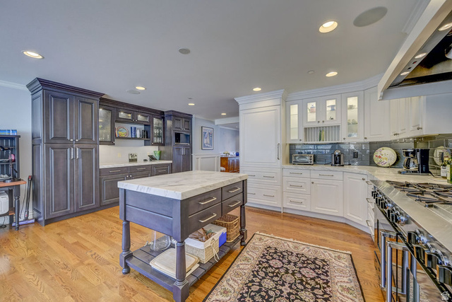 9699 Bypass Road, Unit 5 Alta, UT 84092 - Photo 26 of 54 Gourmet kitchen featuring a wood-finish floor, a large center island with a stone countertop, recessed lighting, and a professional-grade gas range