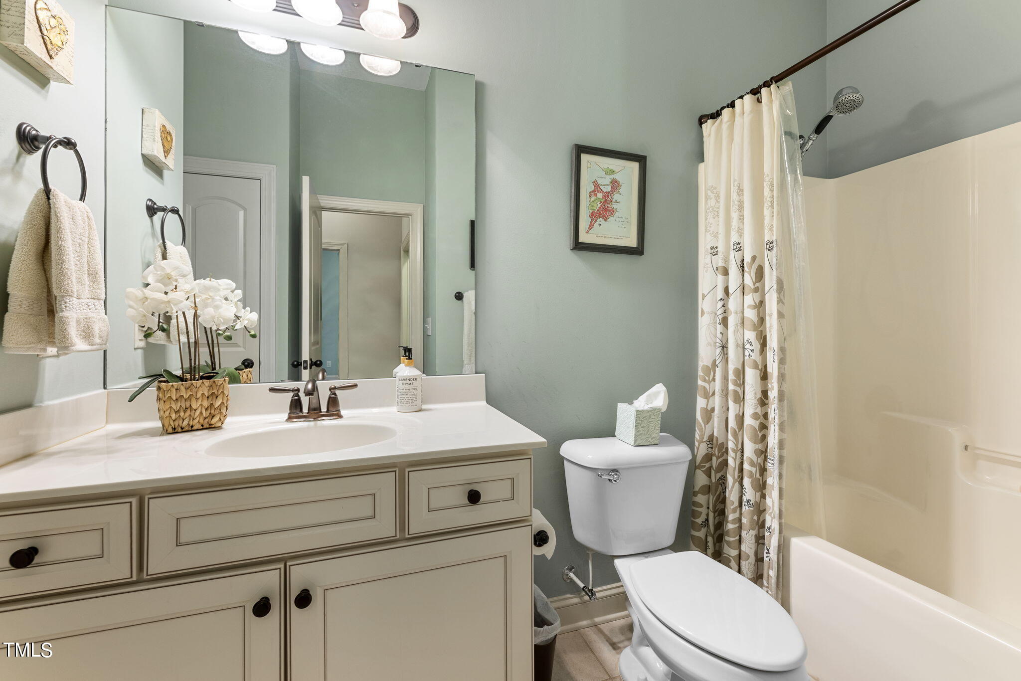 844 Historian Street Raleigh, NC 27603 - Photo 12 of 25 a bathroom with a granite countertop sink mirror vanity and toilet