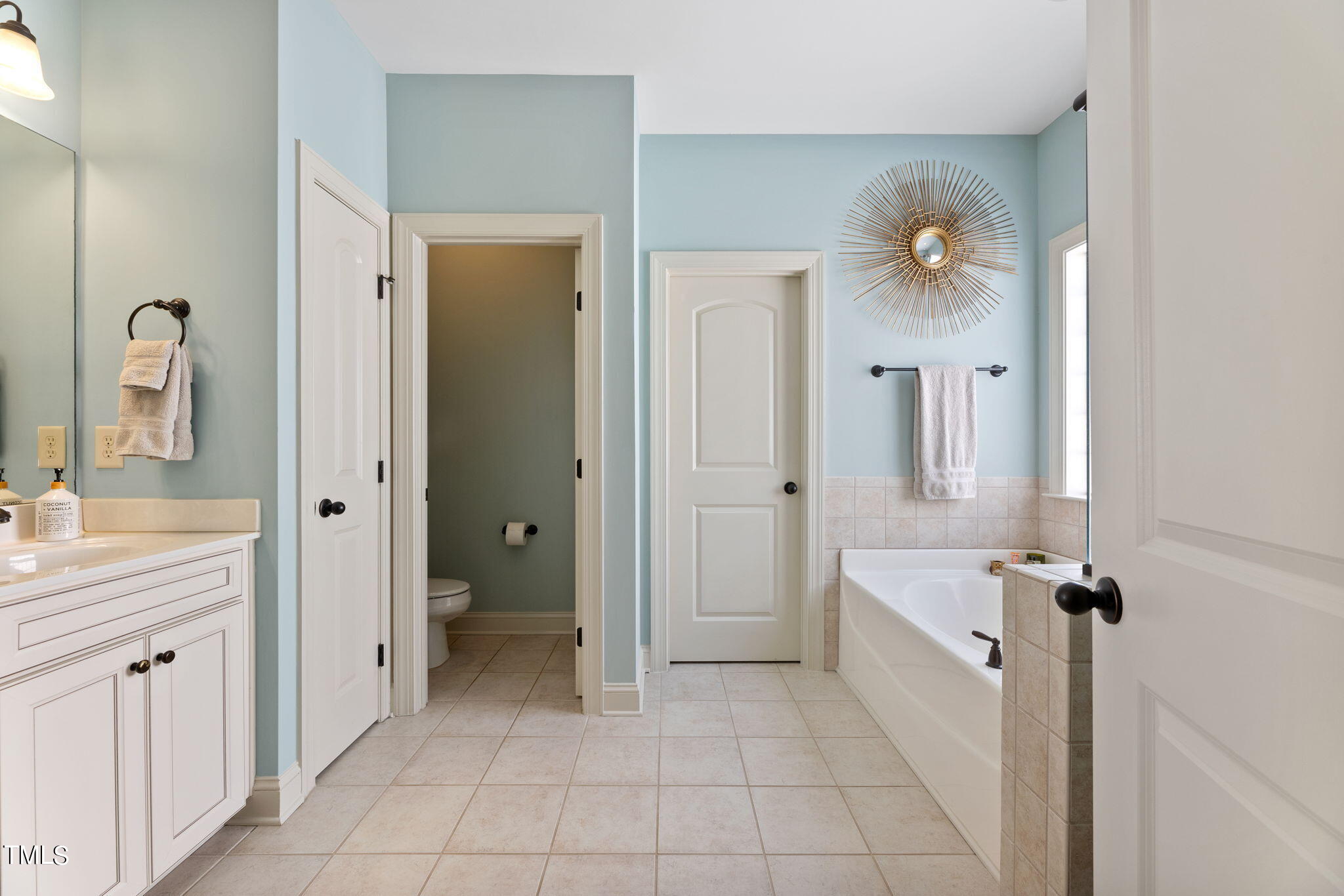 844 Historian Street Raleigh, NC 27603 - Photo 19 of 25 a spacious bathroom with a double vanity sink a mirror and a bathtub