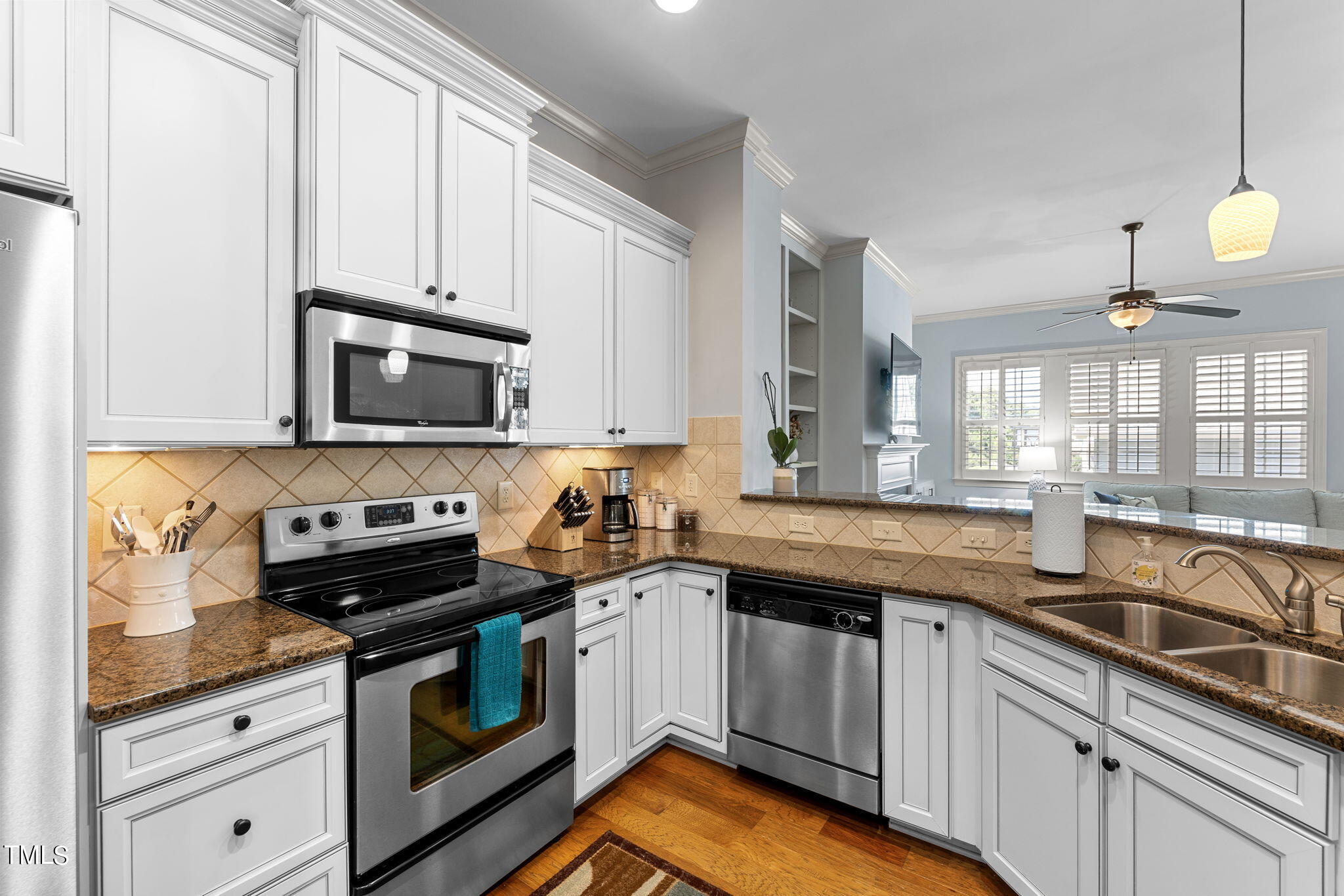 844 Historian Street Raleigh, NC 27603 - Photo 6 of 25 a kitchen with granite countertop a sink a stove and cabinets
