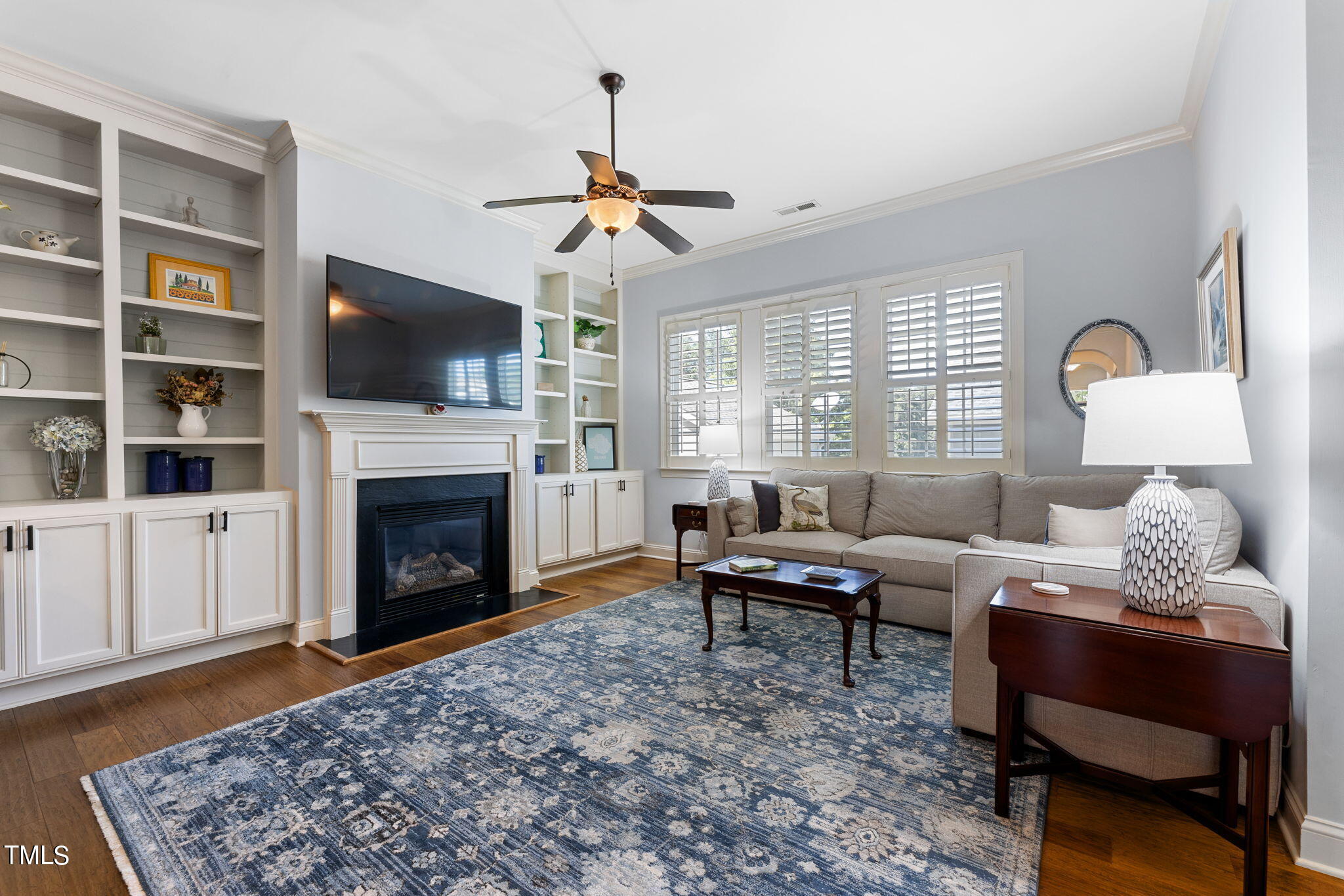 844 Historian Street Raleigh, NC 27603 - Photo 9 of 25 a living room with furniture a flat screen tv and a fireplace