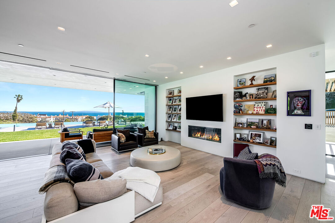 23919 Malibu Road Malibu, CA 90265 - Photo 2 of 33 a living room with furniture large window and a flat screen tv