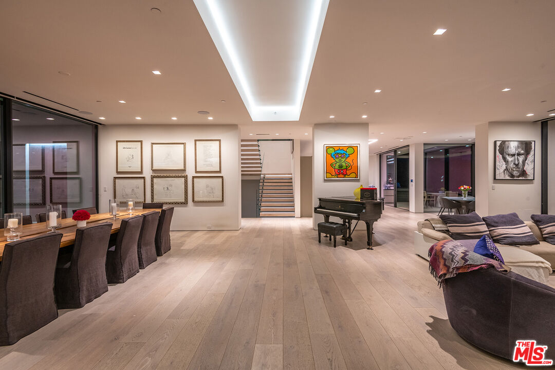 23919 Malibu Road Malibu, CA 90265 - Photo 22 of 33 a living room with furniture a dining table and chairs next to a window