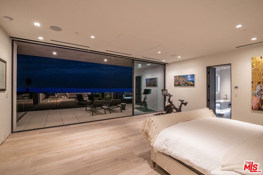 23919 Malibu Road Malibu, CA 90265 - Photo 25 of 33 a bedroom with furniture and a flat screen tv