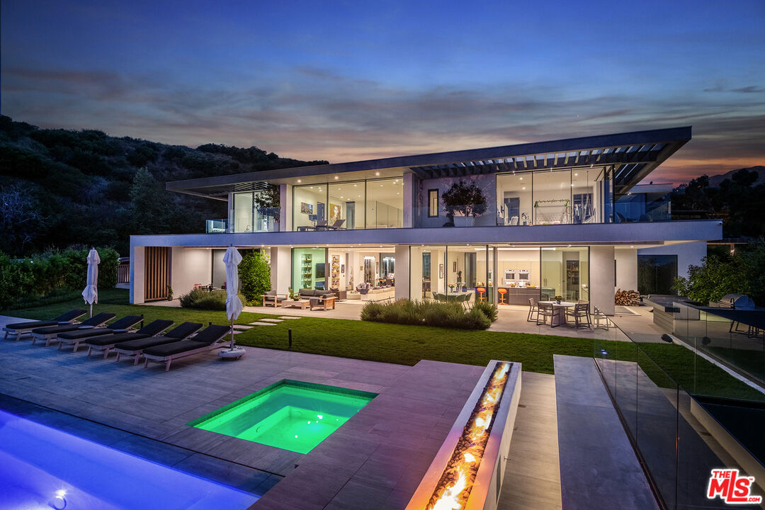 23919 Malibu Road Malibu, CA 90265 - Photo 28 of 33 a view of a house with backyard swimming pool and sitting area