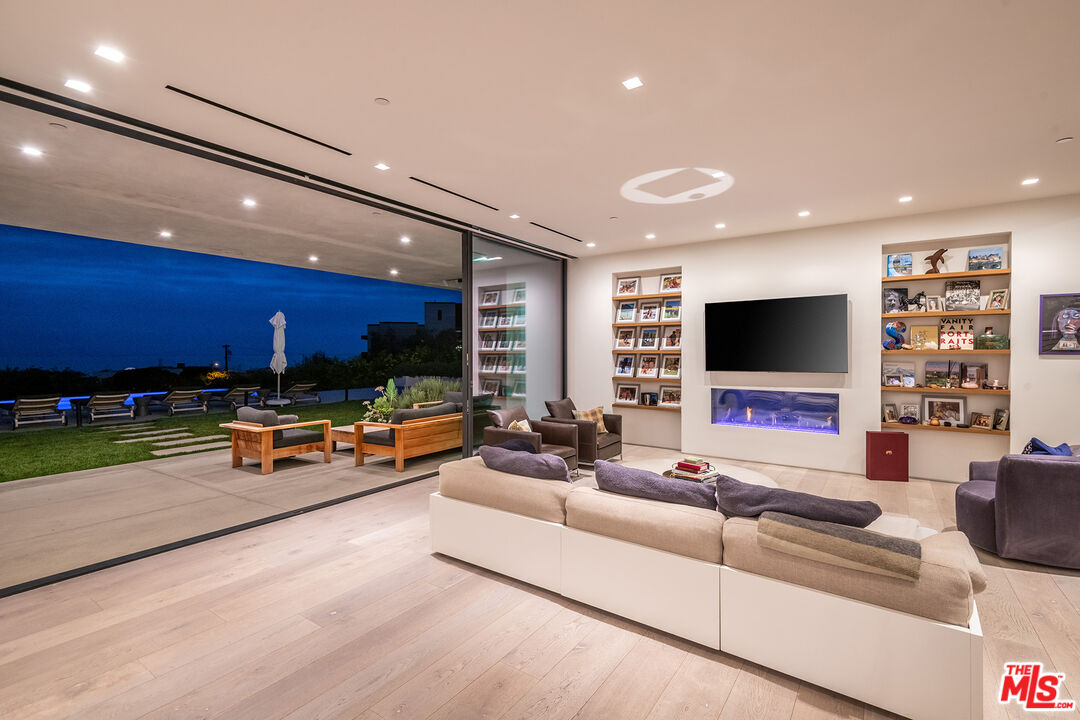 23919 Malibu Road Malibu, CA 90265 - Photo 30 of 33 a living room with furniture and a flat screen tv