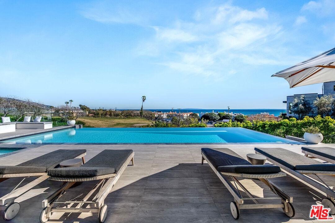 23919 Malibu Road Malibu, CA 90265 - Photo 4 of 33 an aerial view of a chairs and table on the terrace