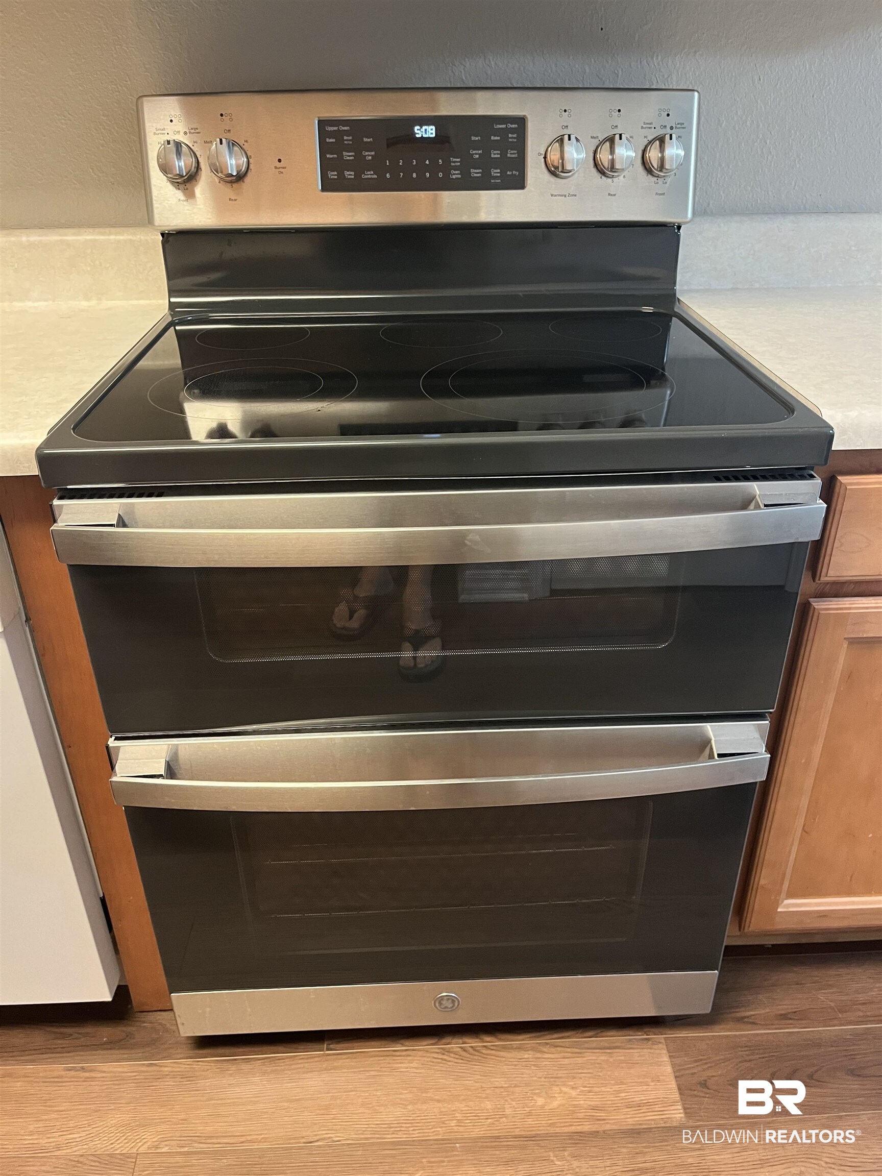 309 Cluster Street Foley, AL 36535 - Photo 6 of 38 Stainless steel electric range with a smooth black cooktop and double ovens
