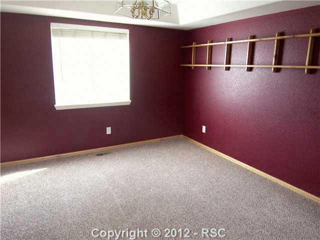 8563 Del Rio Road Peyton, CO 80831 - Photo 3 of 16 Formal Dining Room with Coved Ceiling, Opens to Living Room