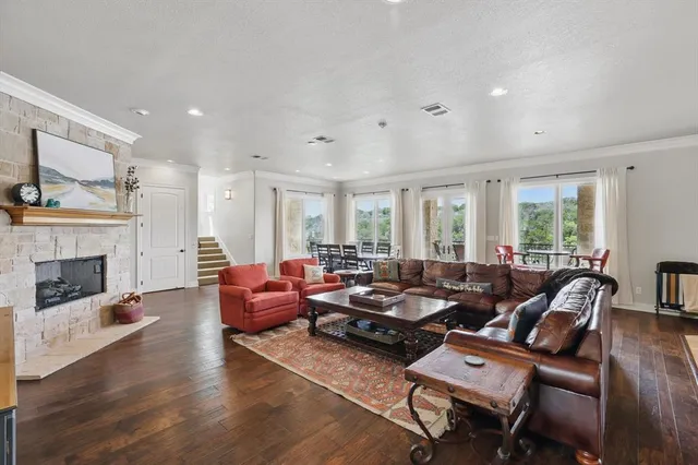 a living room with furniture fireplace and a large window