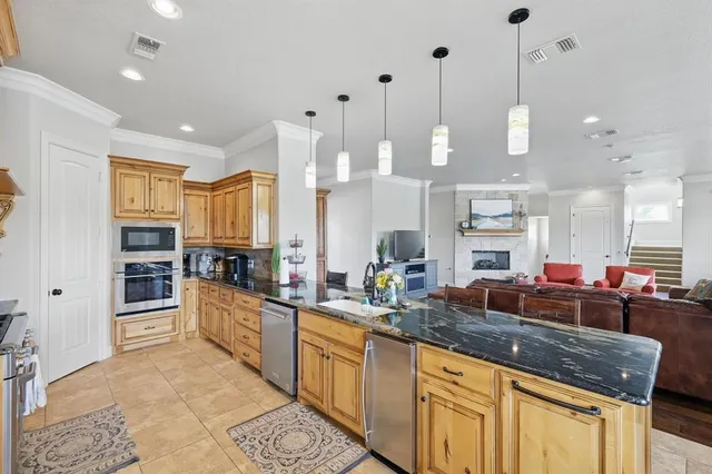 an aerial view of a house with a yard and lake view