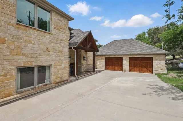 a bathroom with a glass door shower and toilet