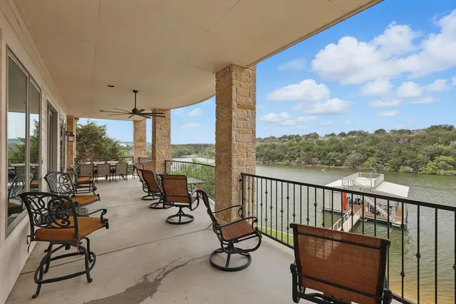 a view of a balcony with chairs and wooden floor