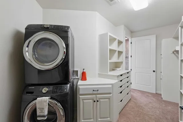 a bedroom with a large bed and a flat tv screen