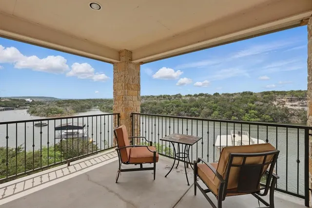 a spacious bedroom with furniture and a large window