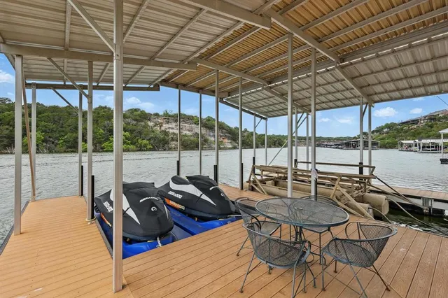 a patio with yard glass top table and chairs