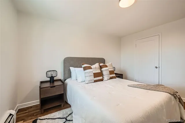 a bedroom with a bed and a lamp