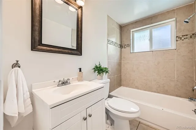 a bathroom with a sink toilet and a mirror
